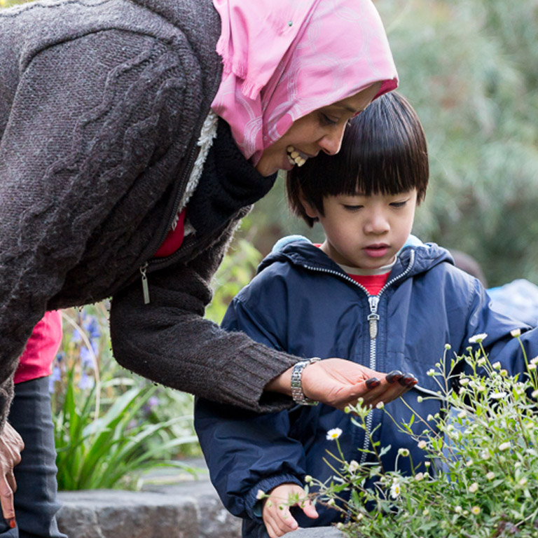 Worker in garden with child